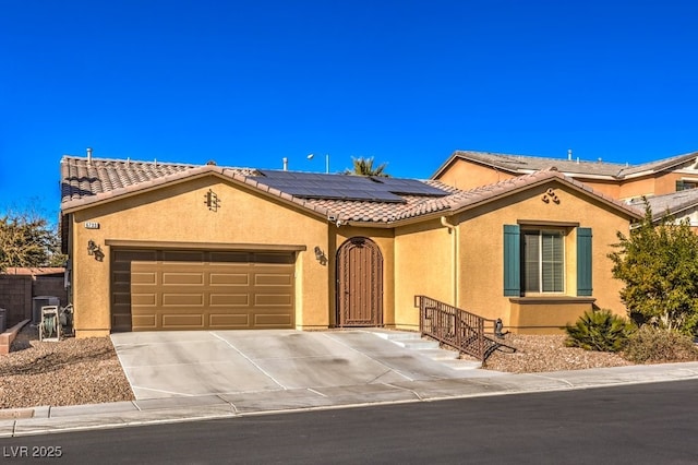 view of front of house featuring a garage and solar panels