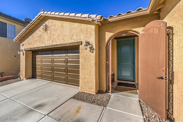 view of exterior entry with a garage