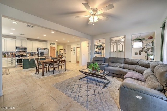 living room featuring ceiling fan and light tile patterned floors