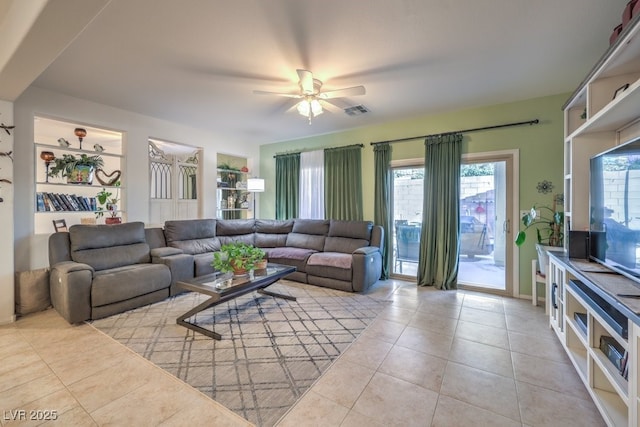 tiled living room with ceiling fan