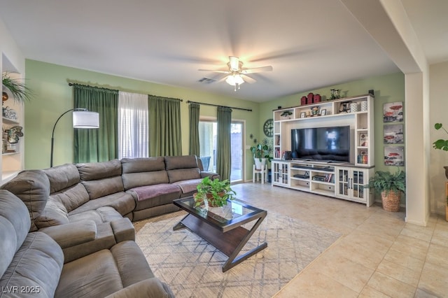 living room featuring ceiling fan and light tile patterned flooring