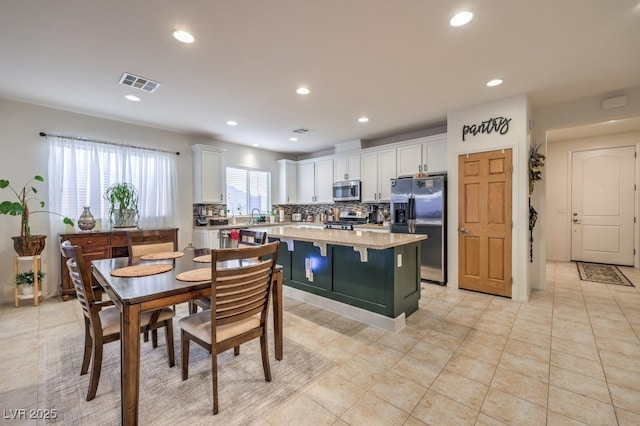 tiled dining room featuring sink