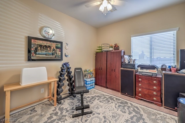 carpeted office with ceiling fan