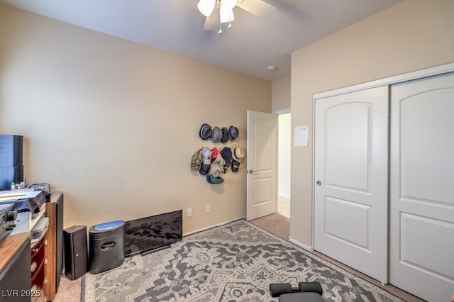 interior space featuring ceiling fan and a closet