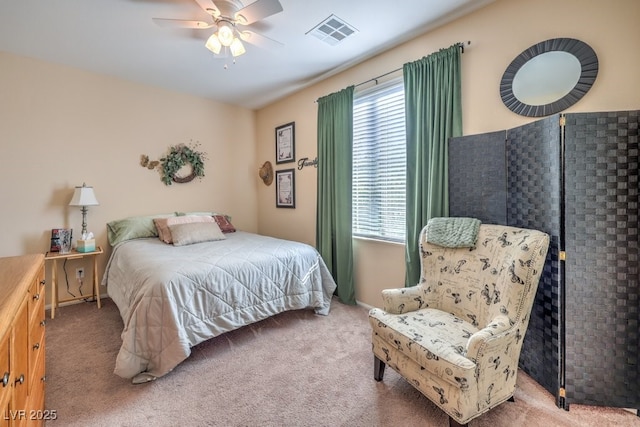 carpeted bedroom featuring ceiling fan and multiple windows