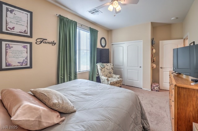 carpeted bedroom featuring ceiling fan and a closet