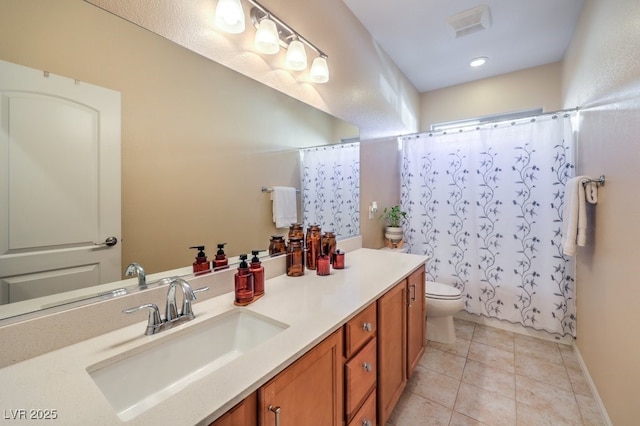 bathroom with tile patterned flooring, vanity, and toilet