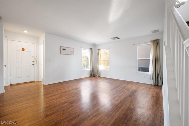 spare room featuring dark wood-type flooring