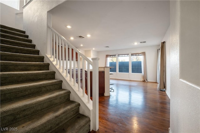 staircase featuring wood-type flooring