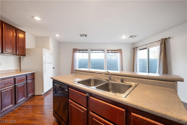 kitchen with dark wood-type flooring, sink, dishwasher, and white refrigerator