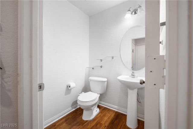 bathroom featuring sink, hardwood / wood-style floors, and toilet