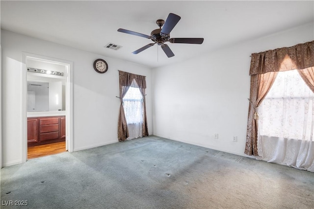 carpeted spare room featuring ceiling fan