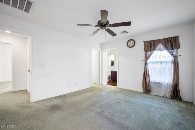 spare room featuring ceiling fan and light colored carpet