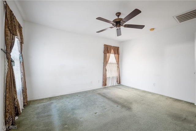 spare room featuring ceiling fan and carpet