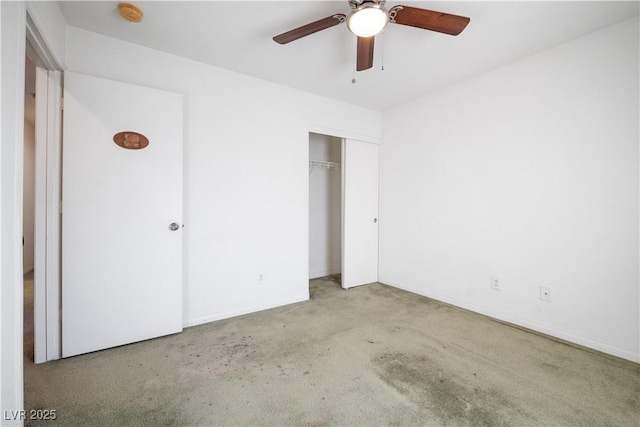 unfurnished bedroom with ceiling fan, light carpet, and a closet