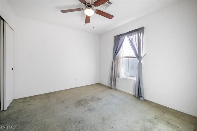 unfurnished room with ceiling fan and light colored carpet