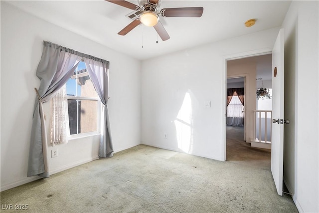 spare room with light carpet and ceiling fan