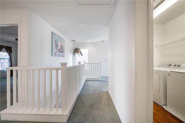 hall with independent washer and dryer and dark colored carpet