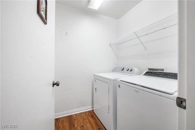 laundry room featuring dark hardwood / wood-style floors and washing machine and clothes dryer