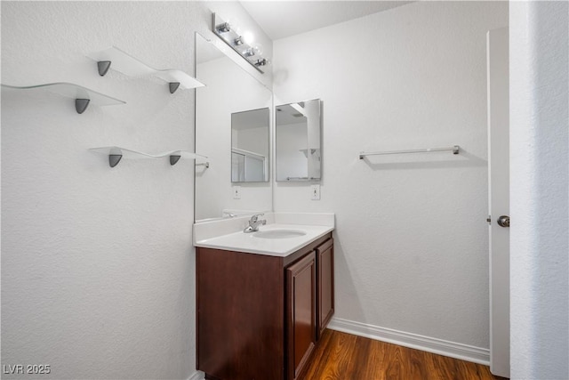 bathroom with vanity and wood-type flooring