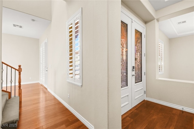 hallway with hardwood / wood-style floors