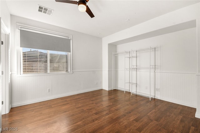 spare room with ceiling fan and dark wood-type flooring