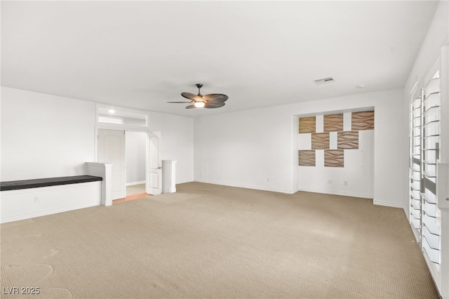 unfurnished living room with ceiling fan and light colored carpet