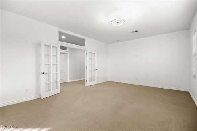 unfurnished bedroom featuring light carpet and french doors