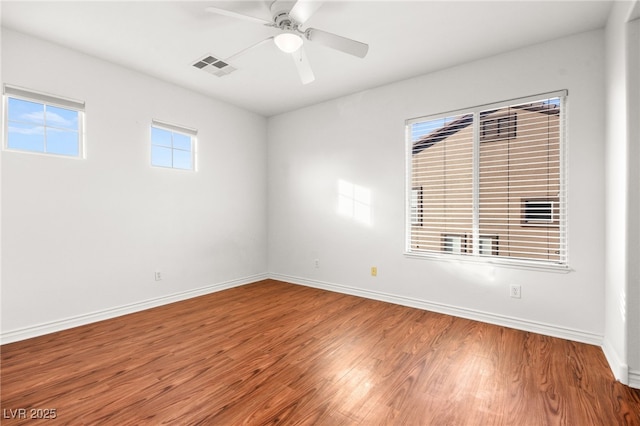 spare room with ceiling fan and hardwood / wood-style flooring