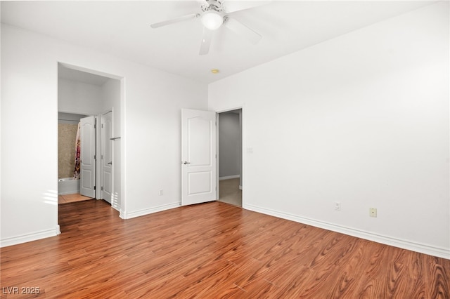 unfurnished bedroom with ceiling fan, light wood-type flooring, and connected bathroom