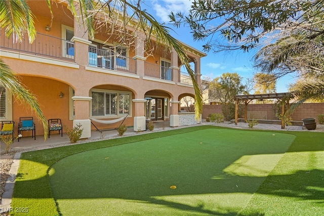 view of community with a pergola and a patio