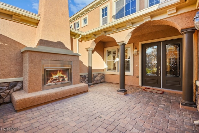 property entrance featuring a patio area