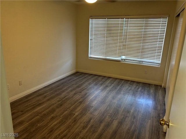 empty room with dark hardwood / wood-style floors