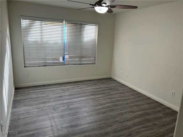 spare room featuring ceiling fan and dark wood-type flooring