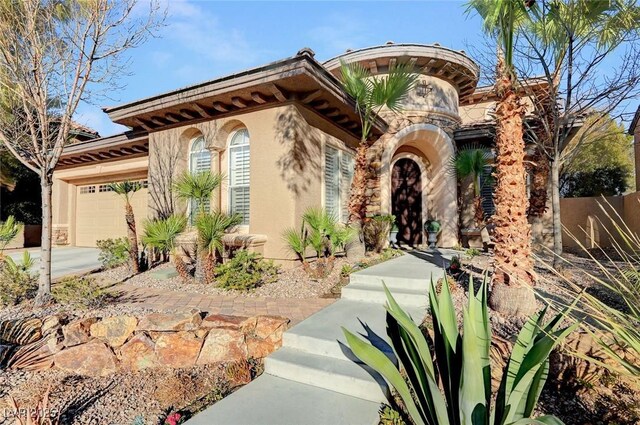 mediterranean / spanish home featuring a garage