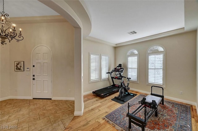 workout area with a notable chandelier