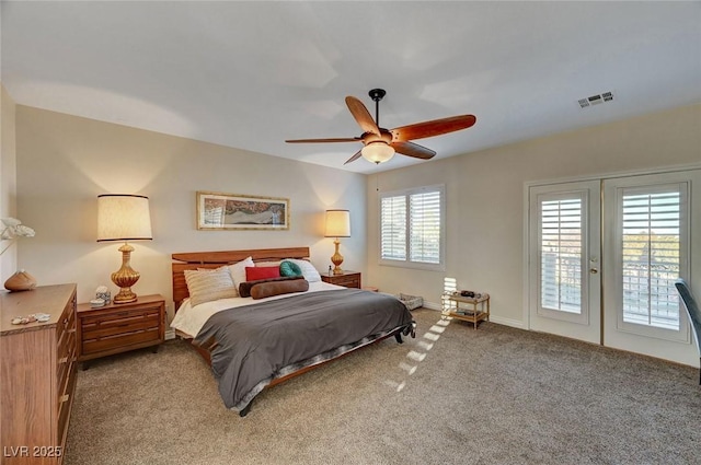 bedroom with ceiling fan, access to exterior, multiple windows, and light carpet