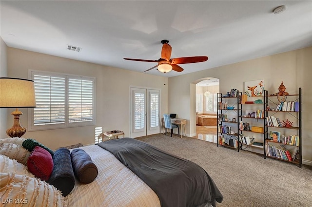 carpeted bedroom featuring ceiling fan and connected bathroom