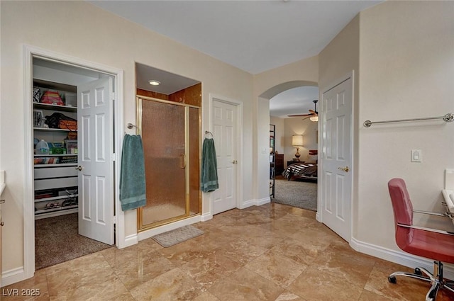 bathroom with ceiling fan and walk in shower