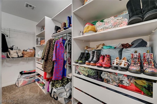 walk in closet featuring carpet flooring