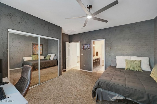 bedroom featuring ceiling fan, a closet, carpet, and ensuite bathroom