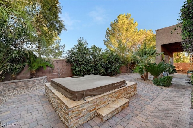 view of patio featuring a covered hot tub