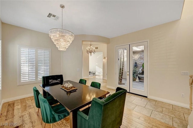 dining space with an inviting chandelier and wood-type flooring