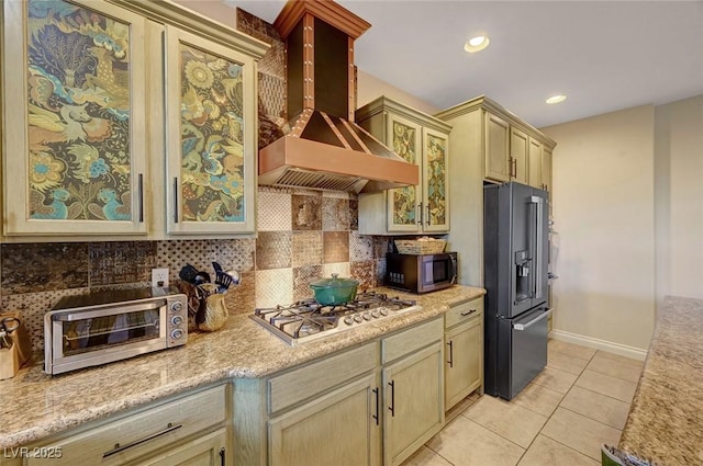 kitchen featuring backsplash, light tile patterned floors, stainless steel appliances, and custom exhaust hood