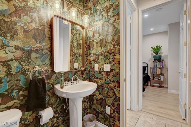 bathroom featuring toilet and tile patterned flooring