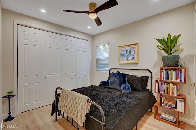 bedroom featuring ceiling fan, a closet, and light hardwood / wood-style floors