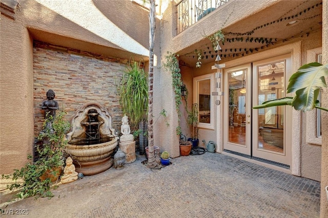 entrance to property with french doors and a patio