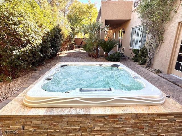 view of swimming pool featuring an outdoor hot tub