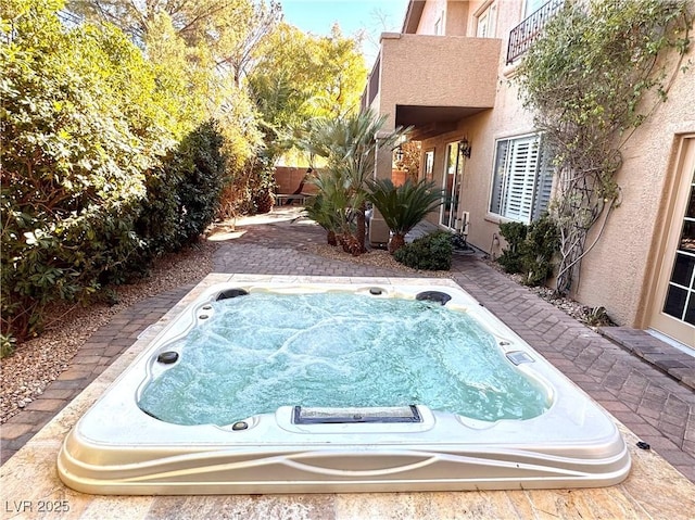 view of swimming pool featuring an outdoor hot tub