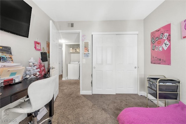 carpeted bedroom with washer / clothes dryer and a closet